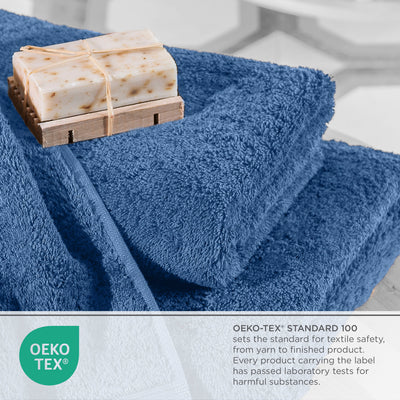 Blue towels stacked with a bar of soap on a wooden soap dish, featuring an Oeko-Tex certification label.
