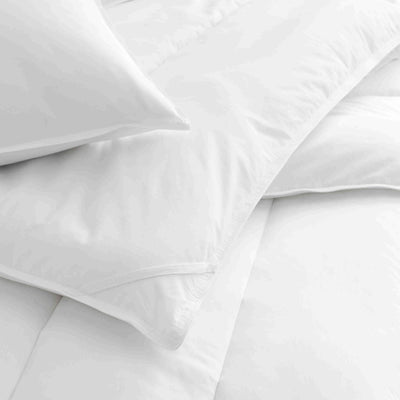 White standard pillow and pillow protector set, featuring a smooth fabric and clean design.