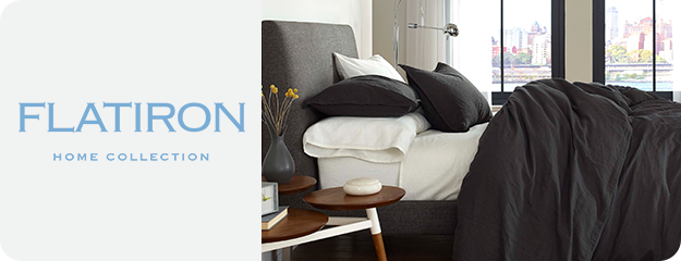 Bedroom with gray bedding and 'Flatiron Home Collection' branding.