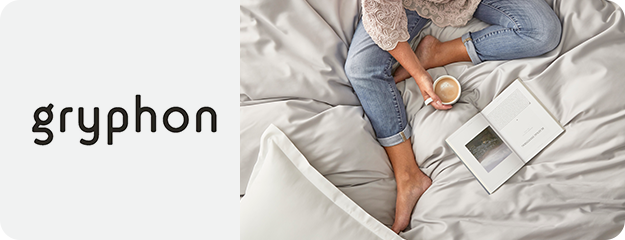 Person sitting on a bed with a cup and photo frame, branded 'gryphon'.