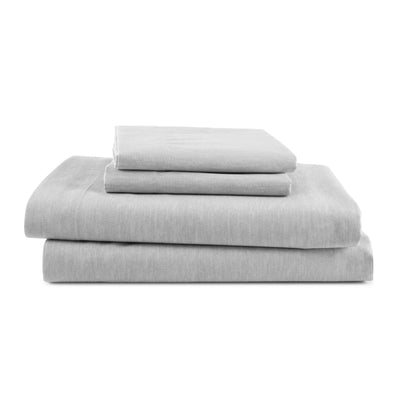 Gray sheet set stacked neatly, including a fitted sheet, flat sheet, and pillowcases.
