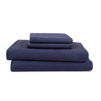 Navy blue sheet set stacked, including fitted sheet, flat sheet, and pillowcases.