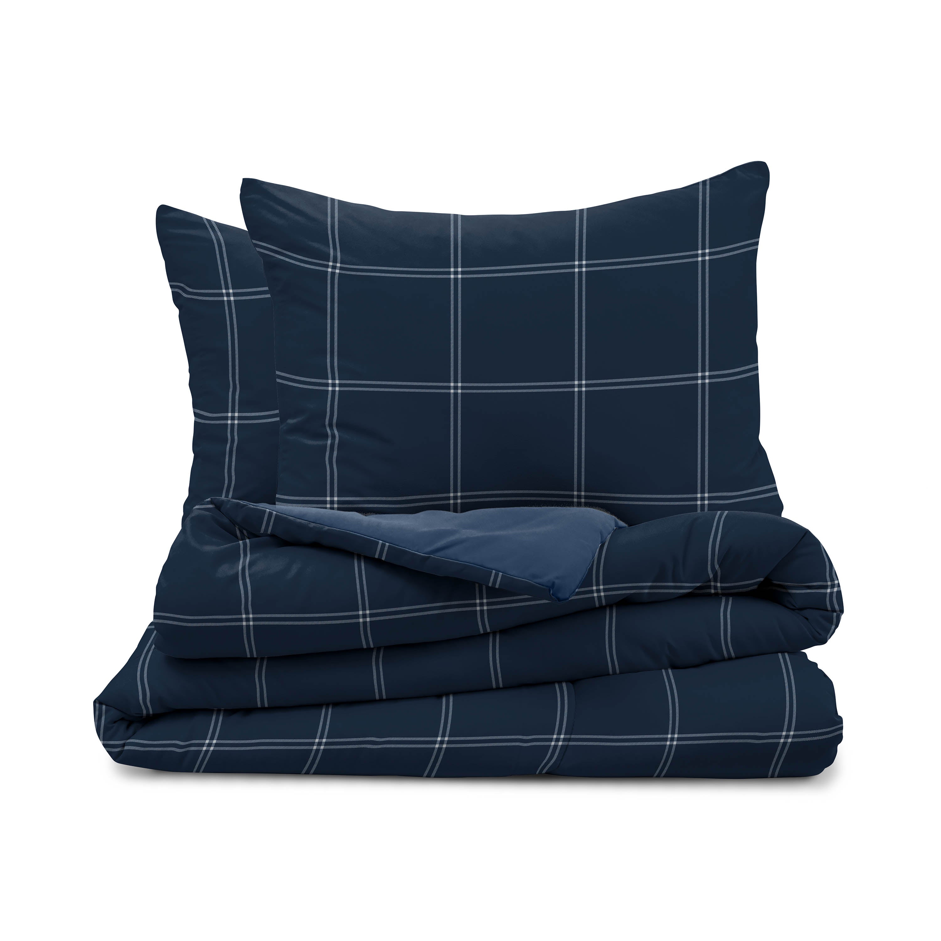 Reversible comforter set featuring a navy blue plaid design with matching pillow shams.
