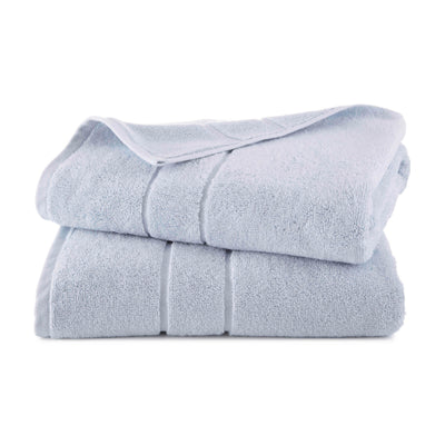 Two stacked bath towels in a light blue color with a textured finish.