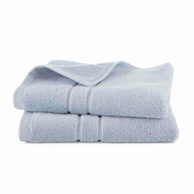 Two stacked light blue hand towels with a textured surface and a folded edge.