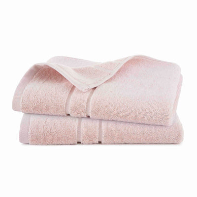Two stacked hand towels in a soft pink color with a textured surface.