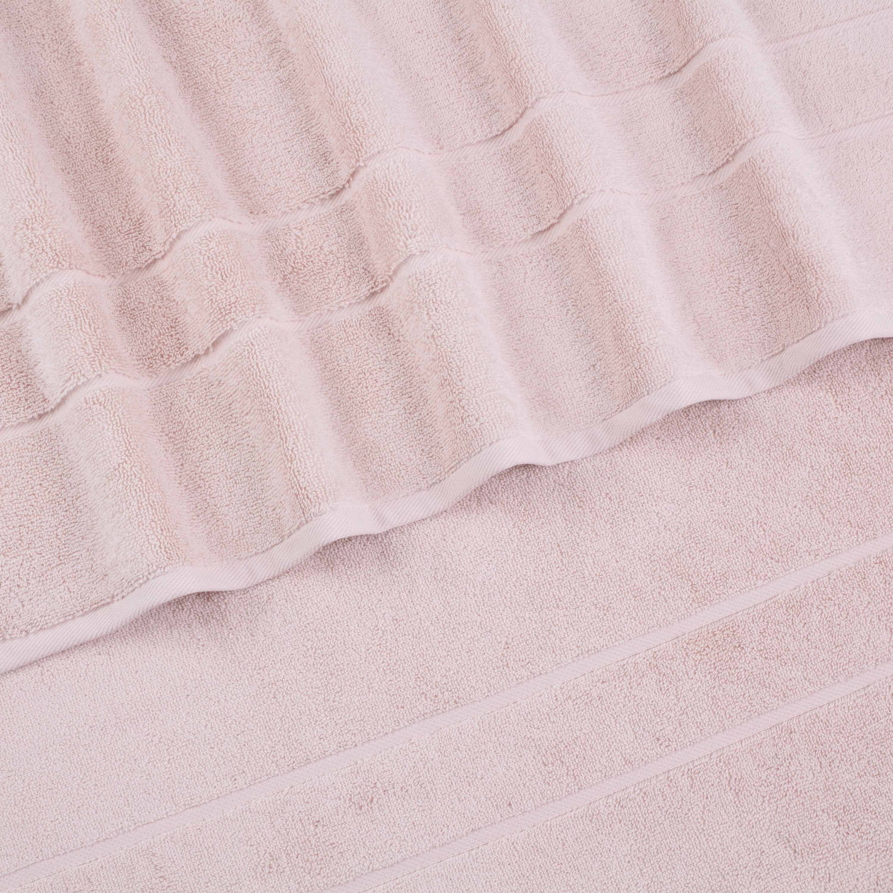 Four soft wash cloths in a light pink color with textured stripes.