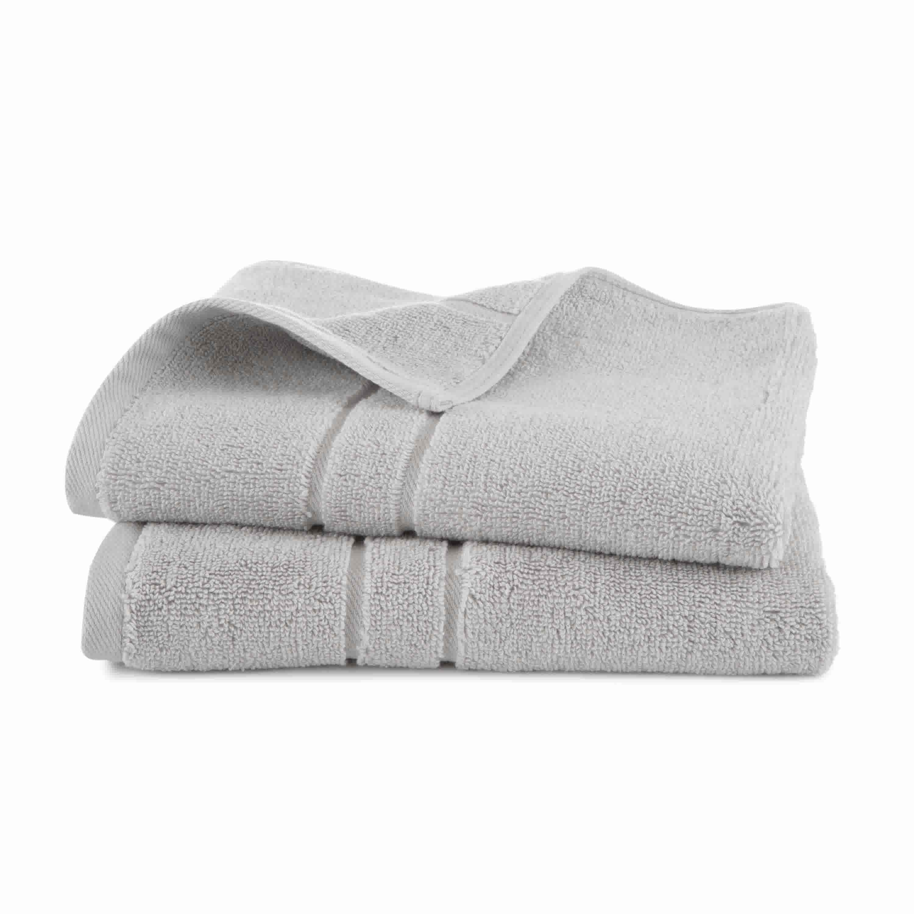Two stacked gray bath towels with a textured surface and a folded edge.