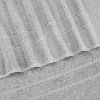 Two soft, gray hand towels stacked with a textured design and subtle stripes.