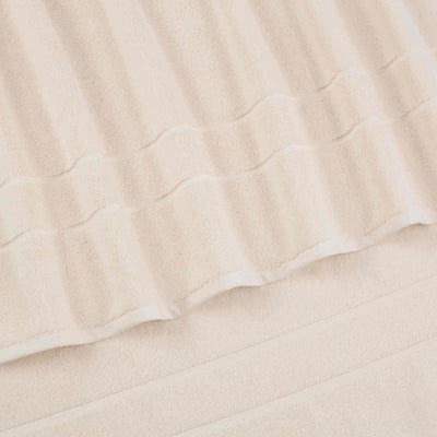 Two beige hand towels with a textured stripe design, stacked on top of each other.