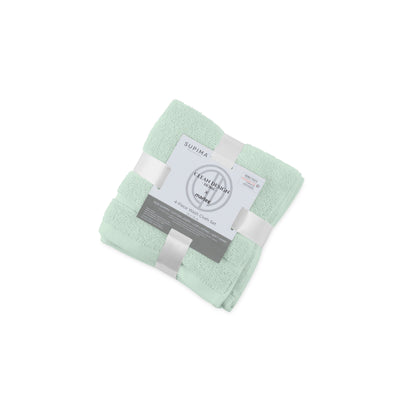 Four mint green wash cloths neatly stacked and wrapped with a label indicating the product details.