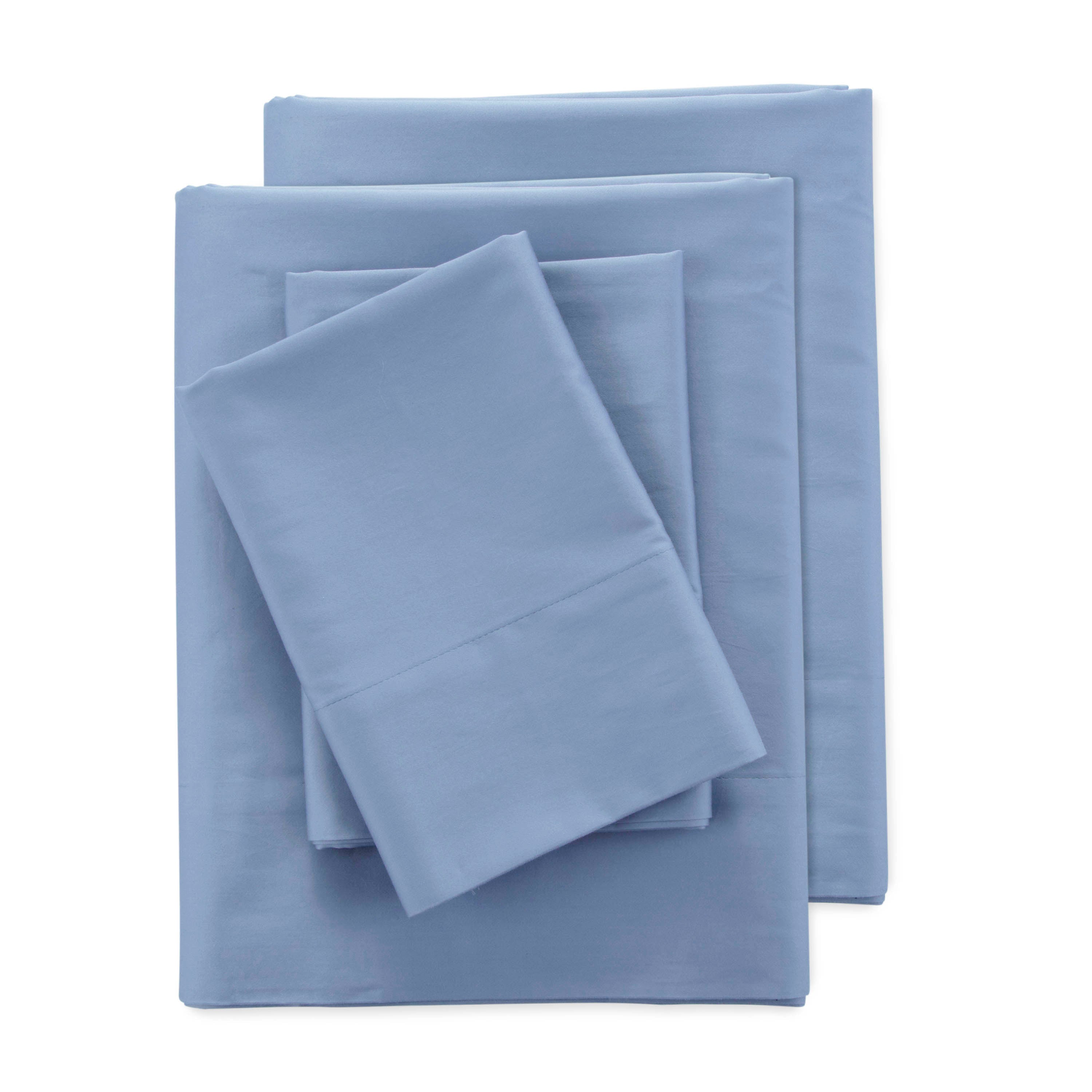 Set of light blue sheets, including fitted and flat sheets along with pillowcases, neatly arranged.