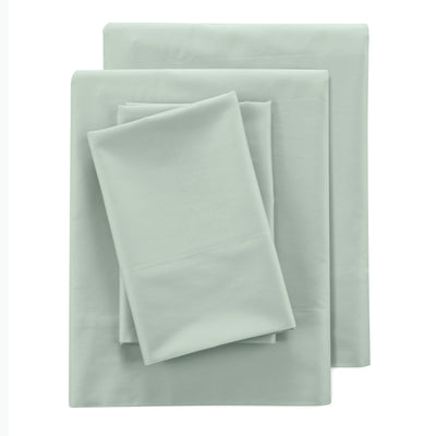 Four-piece sheet set in a light green color, featuring flat and fitted sheets along with pillowcases.