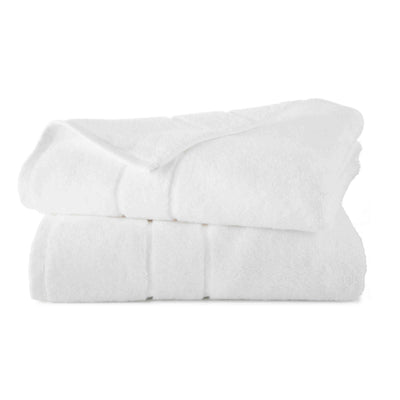 Two stacked white bath towels with a soft texture and subtle ribbed detailing.