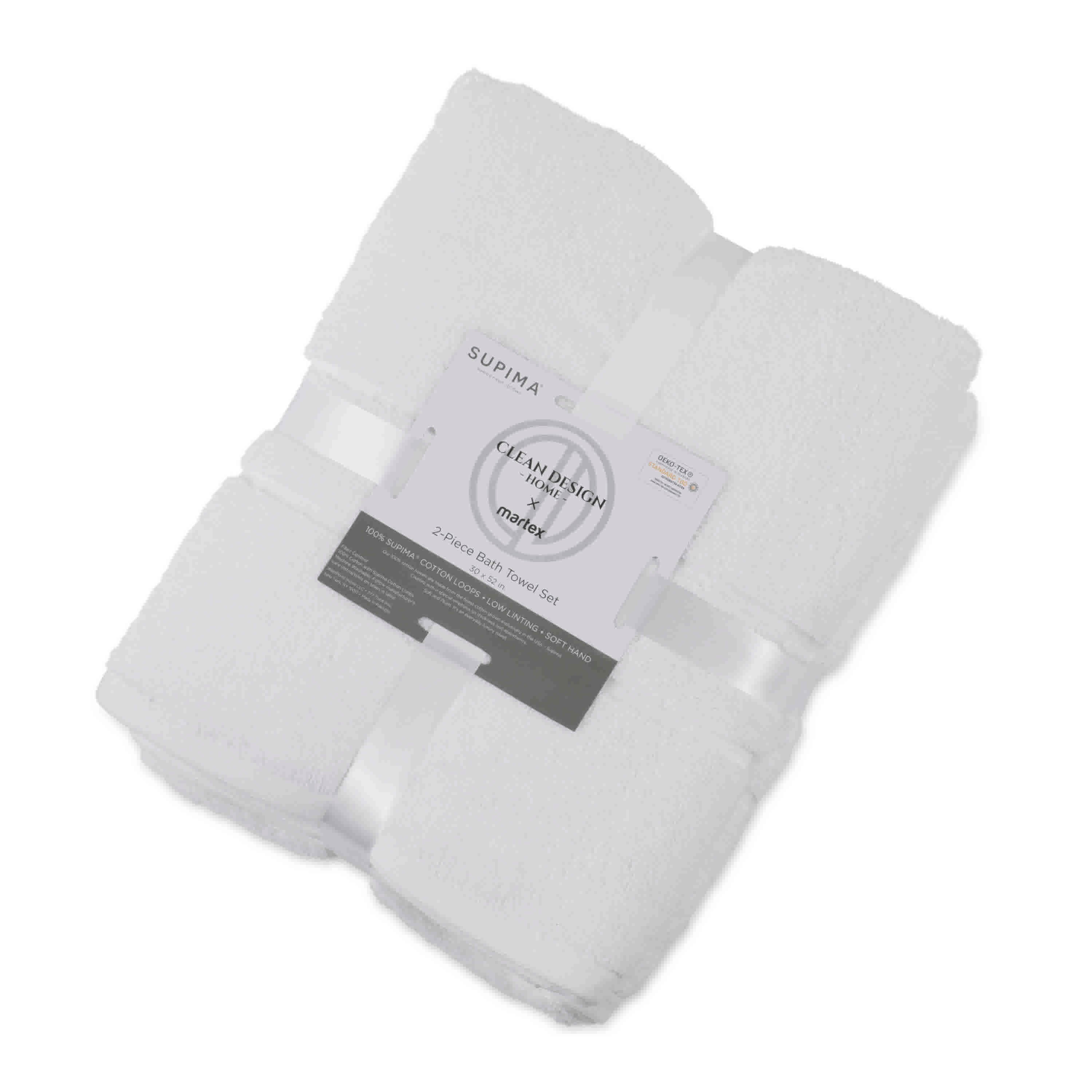 Two white bath towels neatly stacked and tied with a ribbon, featuring a label with product details.