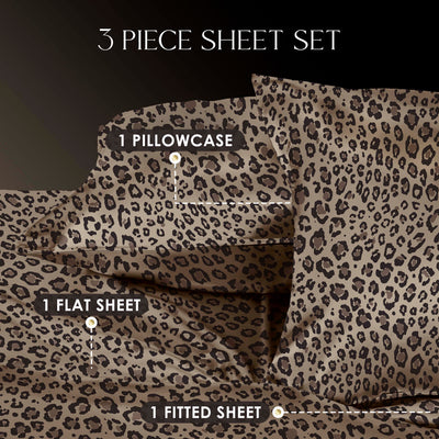 Three-piece satin sheet set featuring a leopard print design, including one pillowcase, one flat sheet, and one fitted sheet.