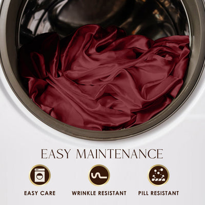 Burgundy satin sheets are shown inside a washing machine drum, highlighting easy maintenance features.