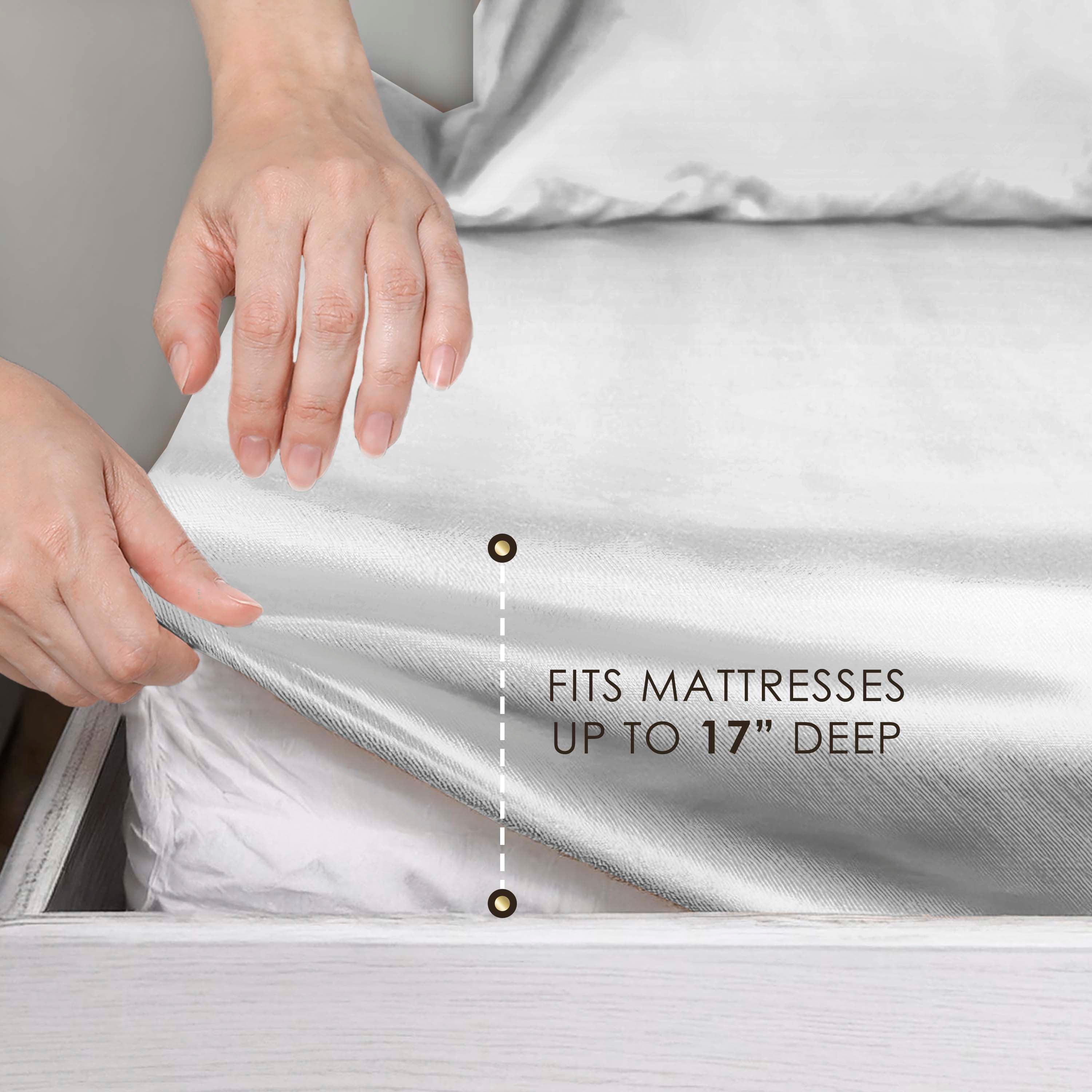 Hands adjusting a satin sheet on a mattress, with text indicating it fits mattresses up to 17 inches deep.