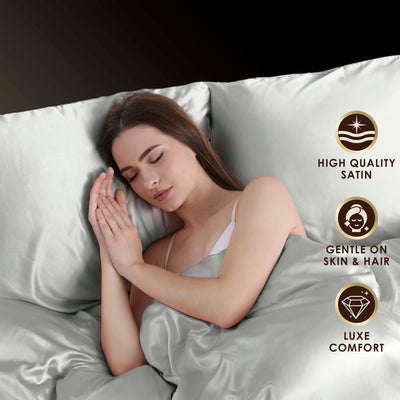 A woman sleeps peacefully on satin sheets, surrounded by soft, smooth fabric.