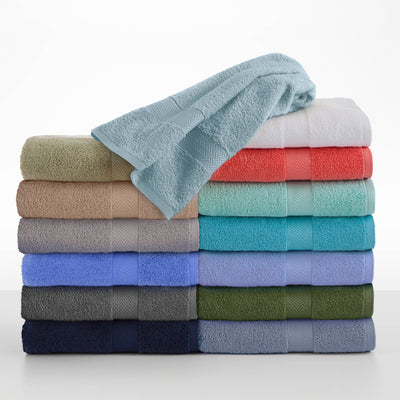 Stack of assorted towels in various colors, including beige, blue, green, and coral, with a light blue towel on top.