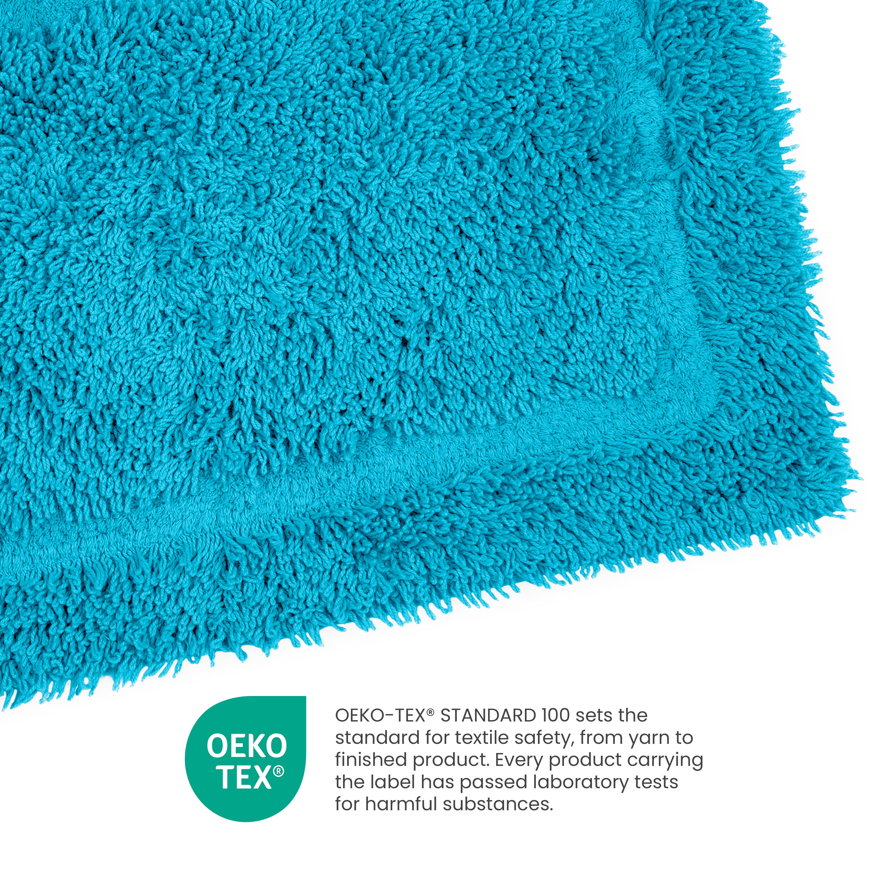 Turquoise ringspun cotton bath rug with a textured surface and a bordered edge.