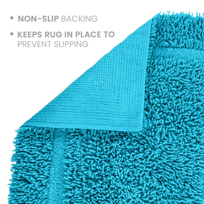 Teal bath rug with a non-slip backing and textured surface for stability.