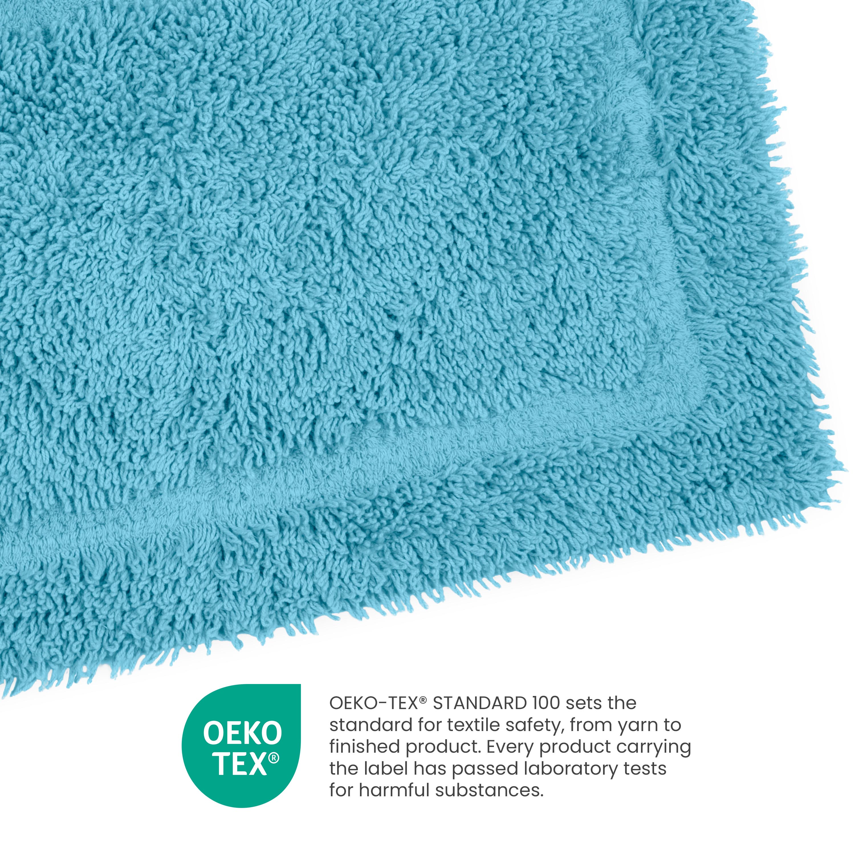 Soft, textured bath rug in a bright blue color with a rectangular shape and a label indicating Oeko-Tex certification.
