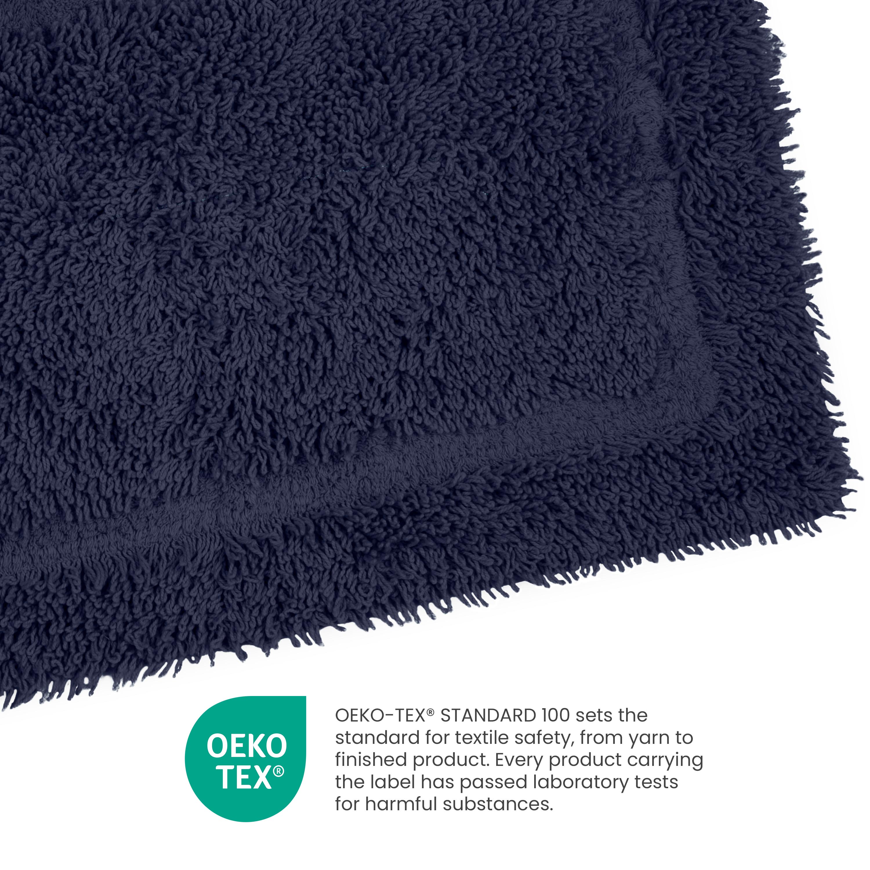 Navy blue ringspun cotton bath rug with a textured surface and a bordered design.