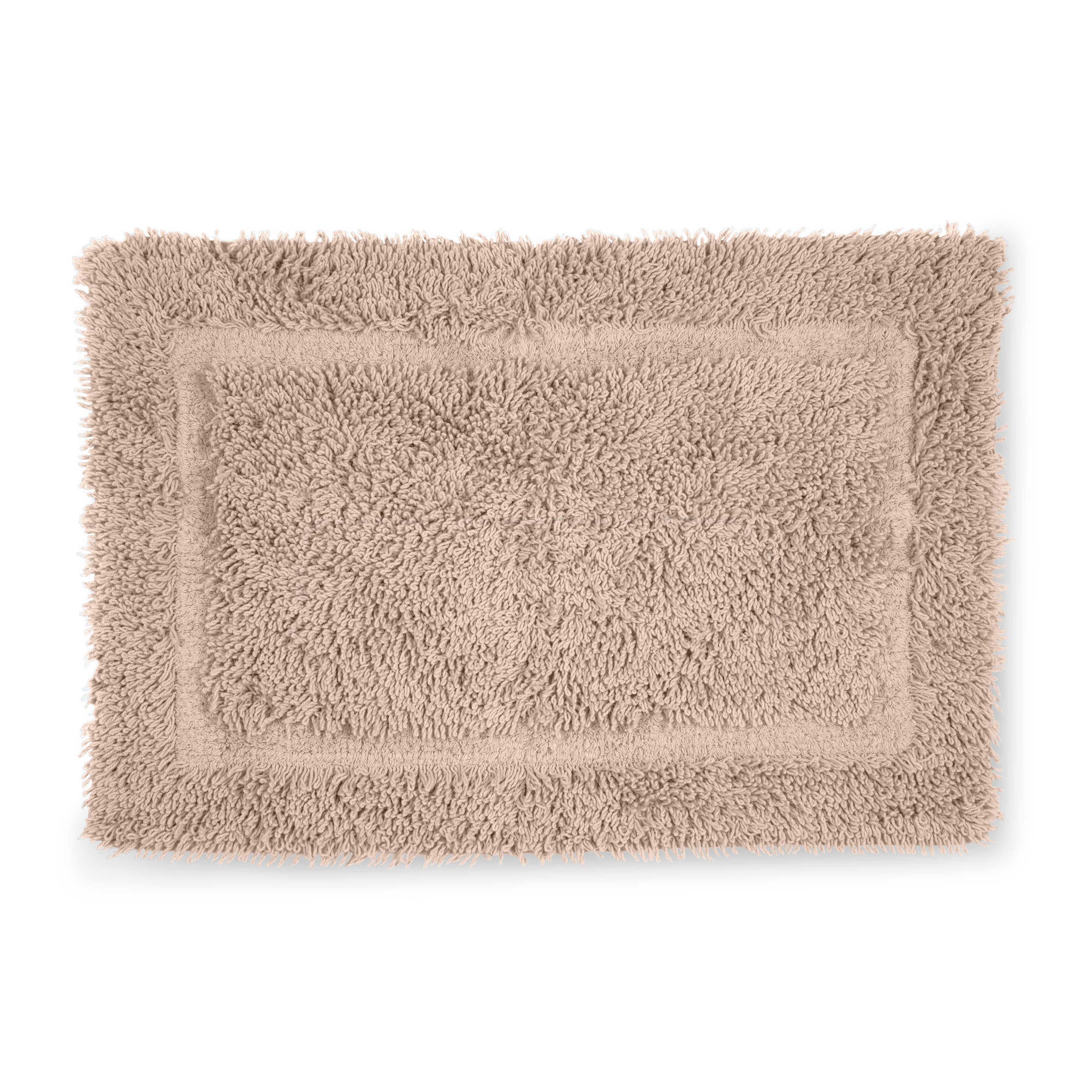 Rectangular bath rug with a plush, textured surface in a light beige color and a bordered design.