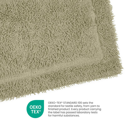 Light green ringspun cotton bath rug with a textured surface and a bordered edge.