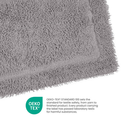 Gray ringspun cotton bath rug with a plush texture and bordered edge.