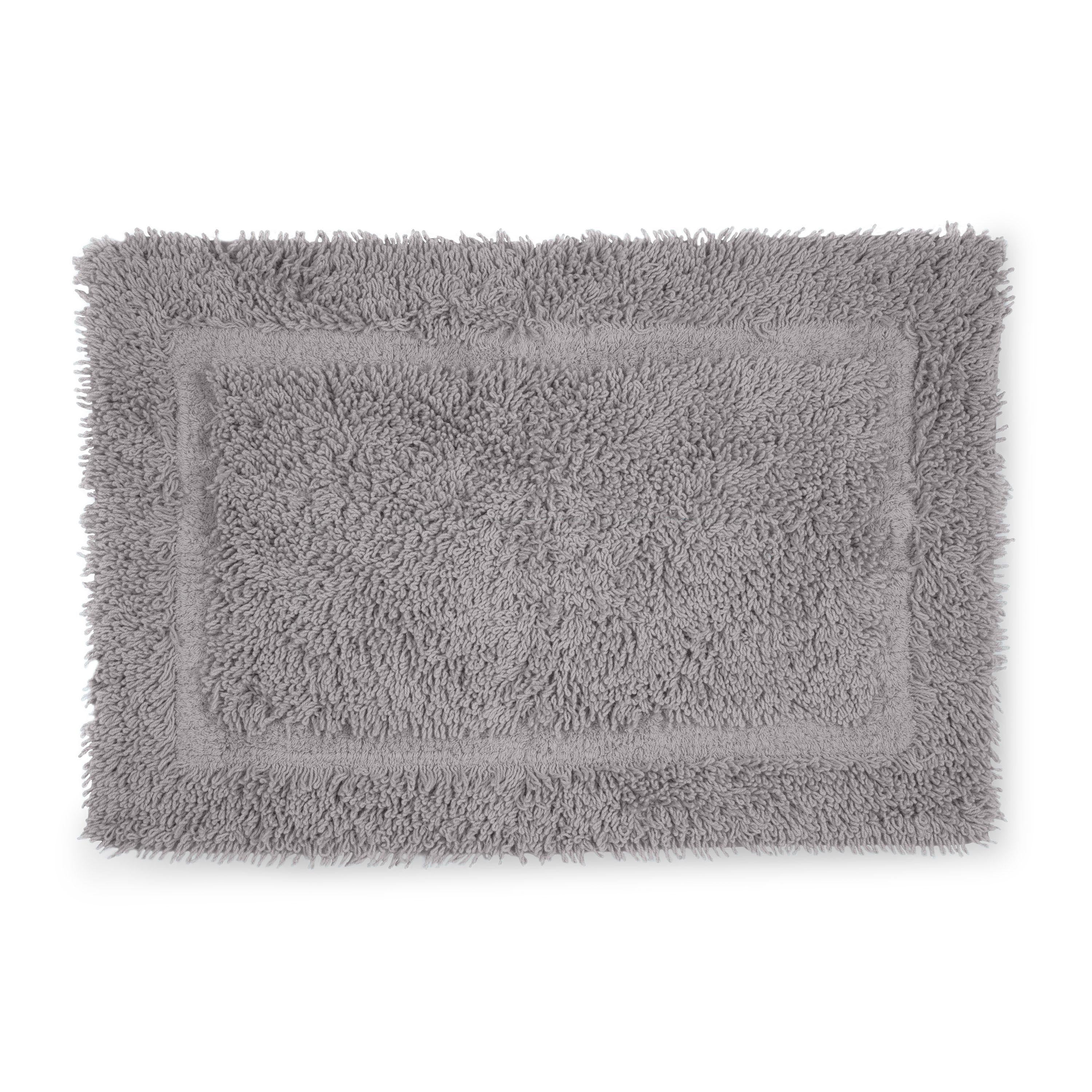 Gray bath rug with a plush, textured surface and a rectangular shape.