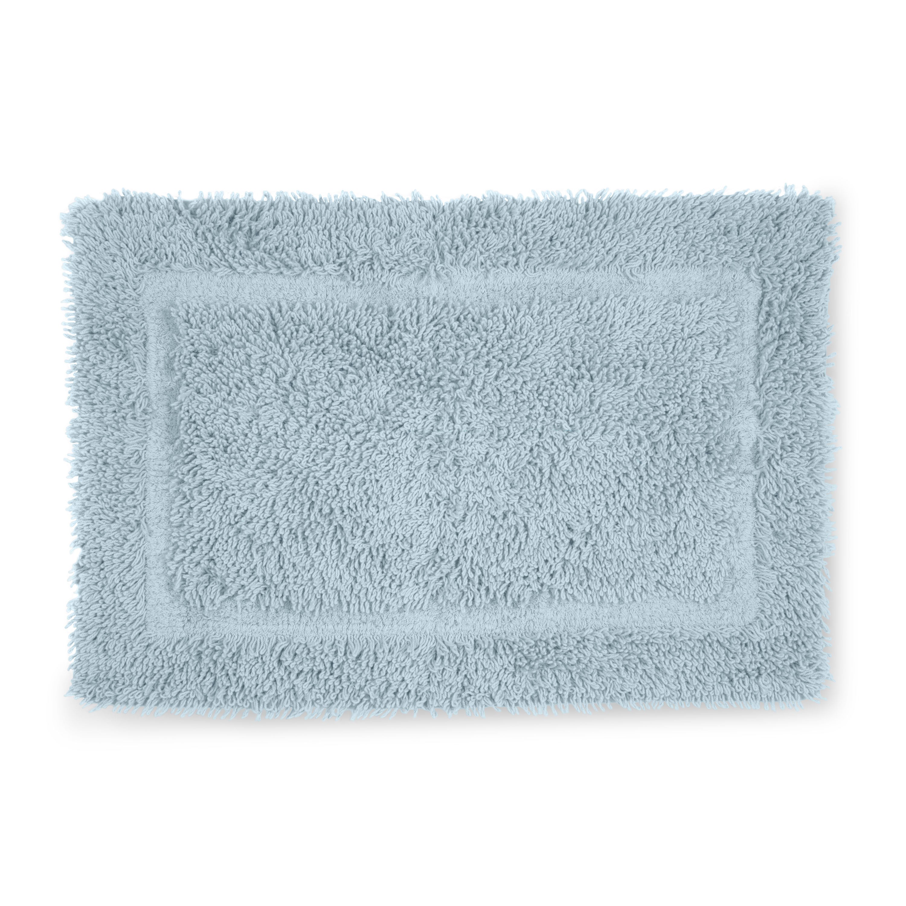 Light blue bath rug with a plush, textured surface and a rectangular shape.