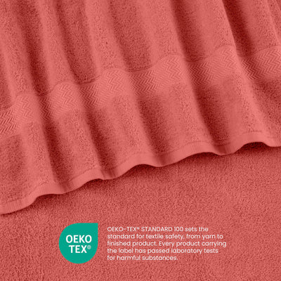 Soft coral towels with a textured stripe design and Oeko-Tex certification for textile safety.