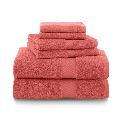 Six coral towels stacked in varying sizes, featuring a textured band design.