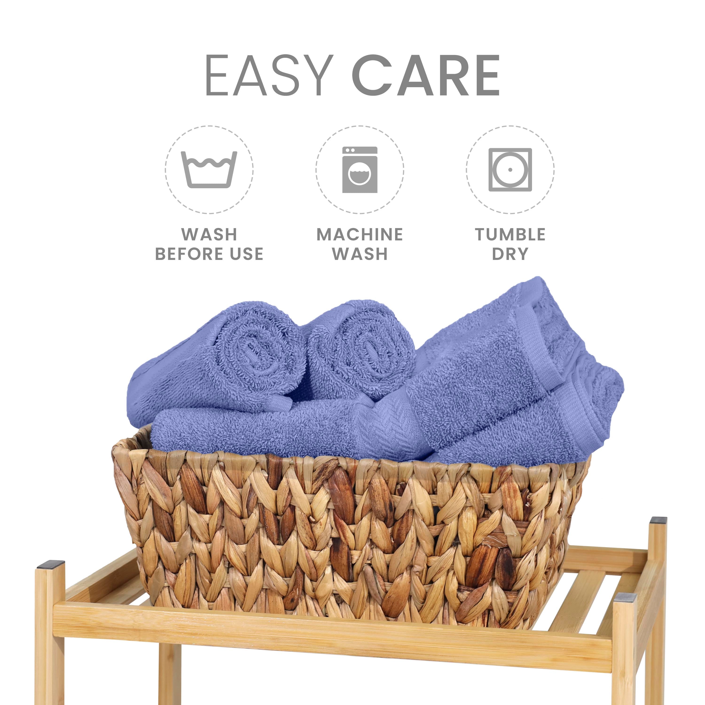 Six rolled purple towels in a woven basket on a wooden stand, with care instructions above.