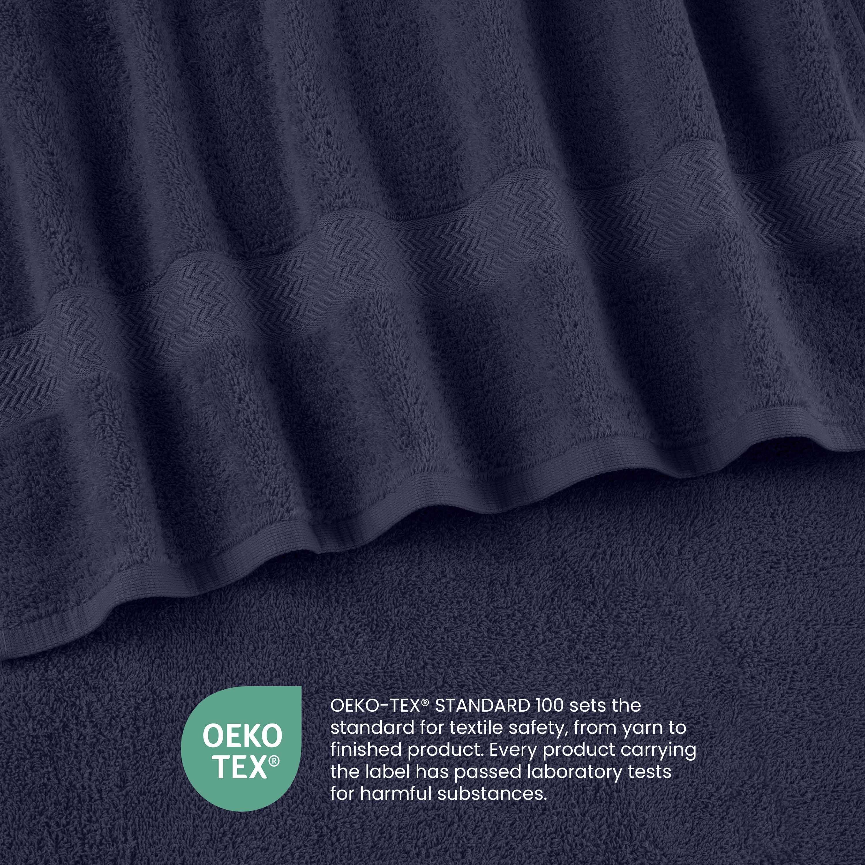 Navy blue towels with a textured stripe design and an Oeko-Tex certification label for textile safety.