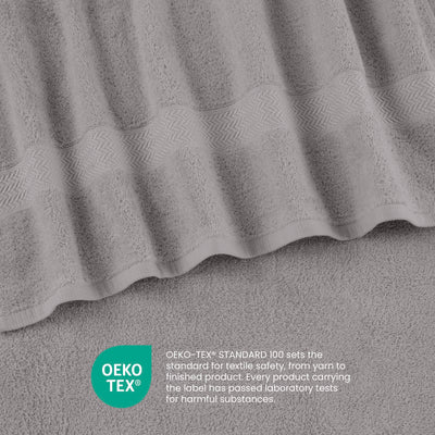 Gray towels with a textured pattern and a label indicating Oeko-Tex certification for textile safety.