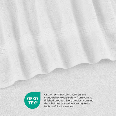 White towels with textured detailing and an Oeko-Tex certification label for textile safety.