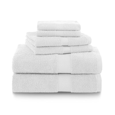 Six white towels stacked neatly, including bath, hand, and washcloth sizes.