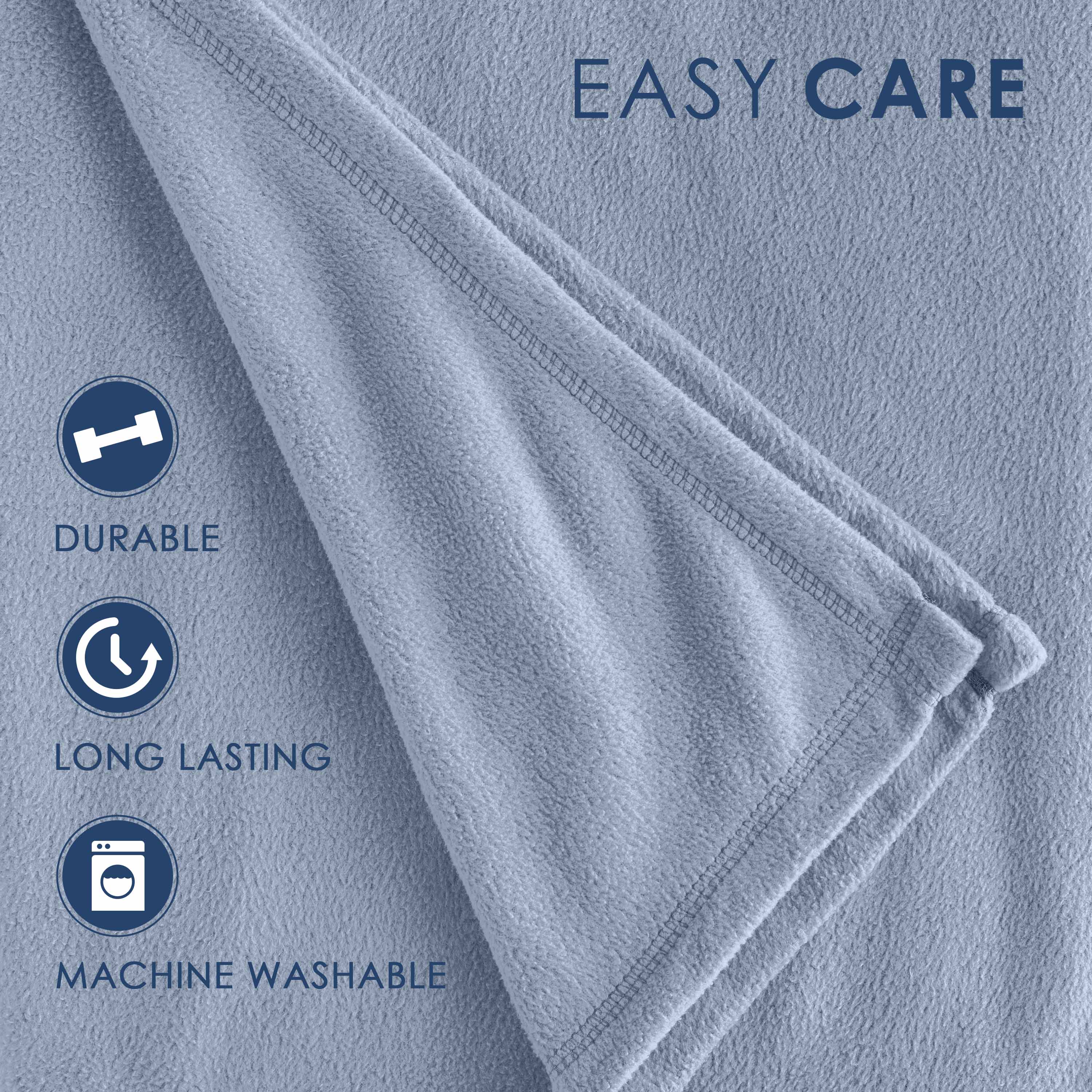 Light blue fleece blanket with a soft texture and stitched edges, featuring care instructions for durability and washability.