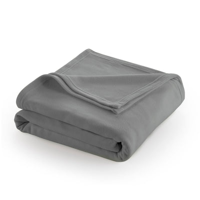 Gray fleece blanket neatly folded with a corner slightly turned down.