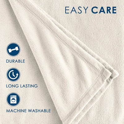 Light beige fleece blanket with a soft texture and stitched edges, featuring care instructions.