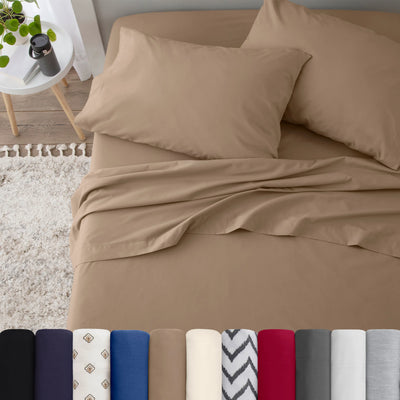 Neatly made bed with beige bedding in a bedroom setting.
