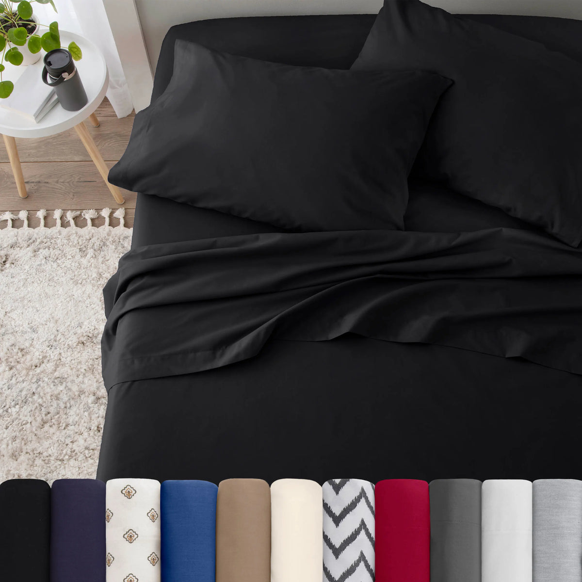Neatly made bed with black bedding in a bedroom setting.