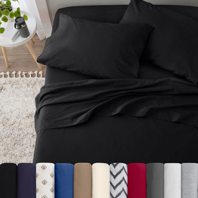Neatly made bed with black bedding in a bedroom setting.