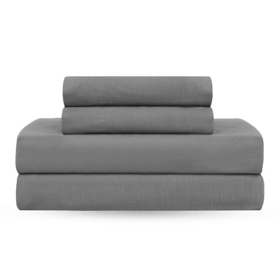 Gray sheet set stacked neatly, consisting of a fitted sheet, flat sheet, and pillowcases.