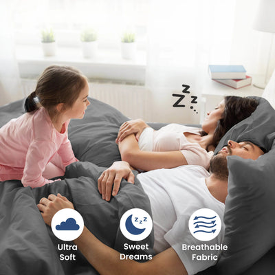 Parent sleeping on a grey bedding