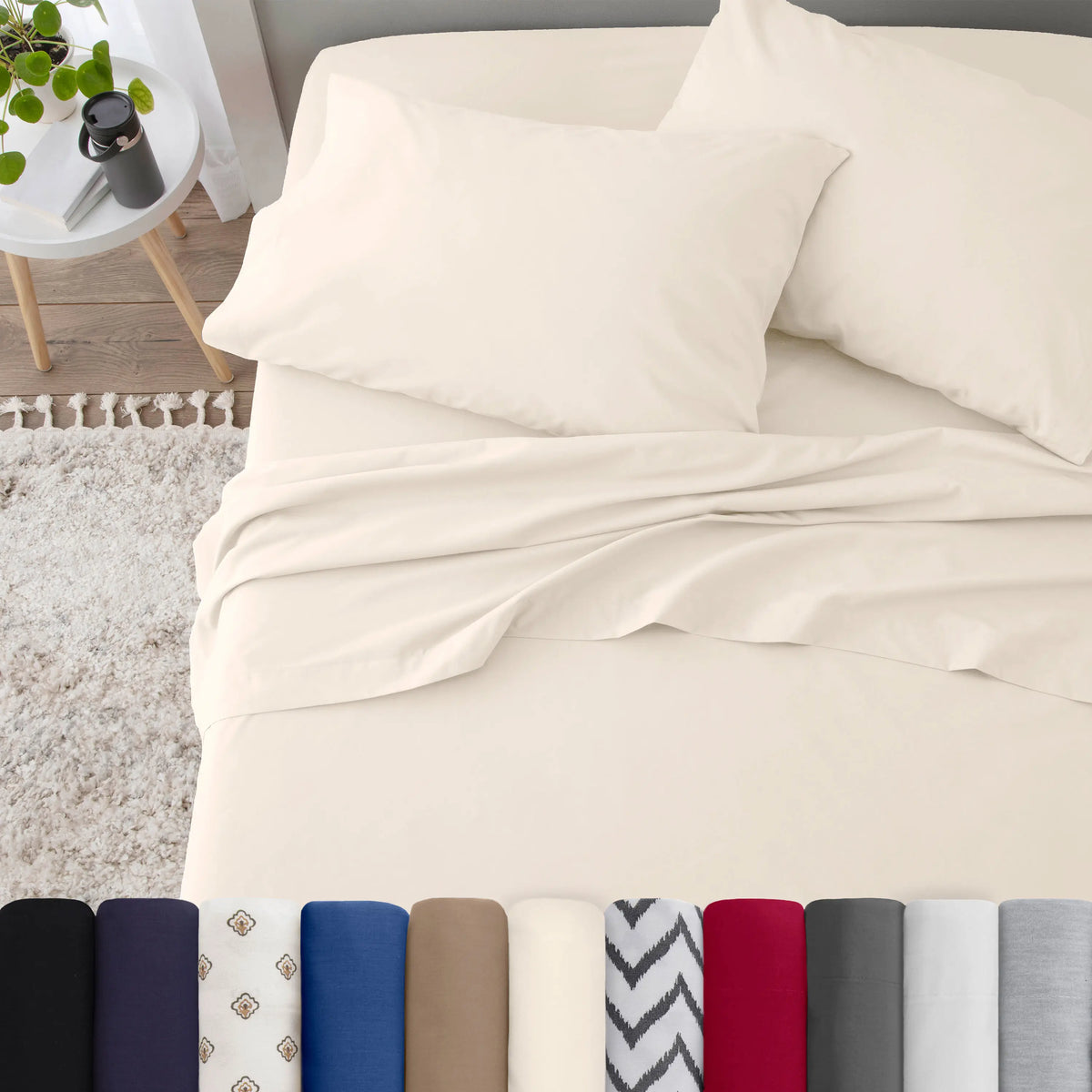 Neatly made bed with ivory bedding in a bedroom setting.