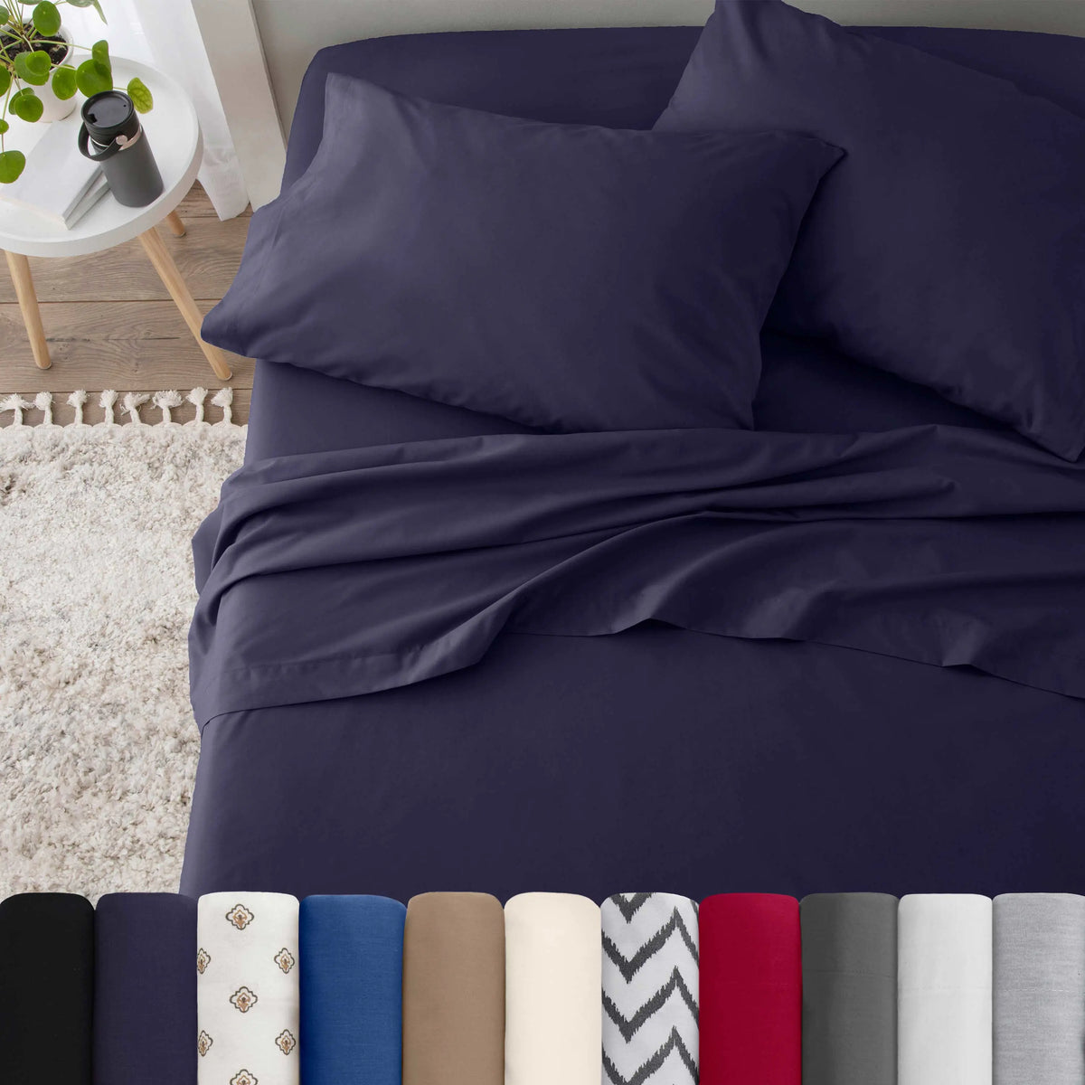 Neatly made bed with navy bedding in a bedroom setting.